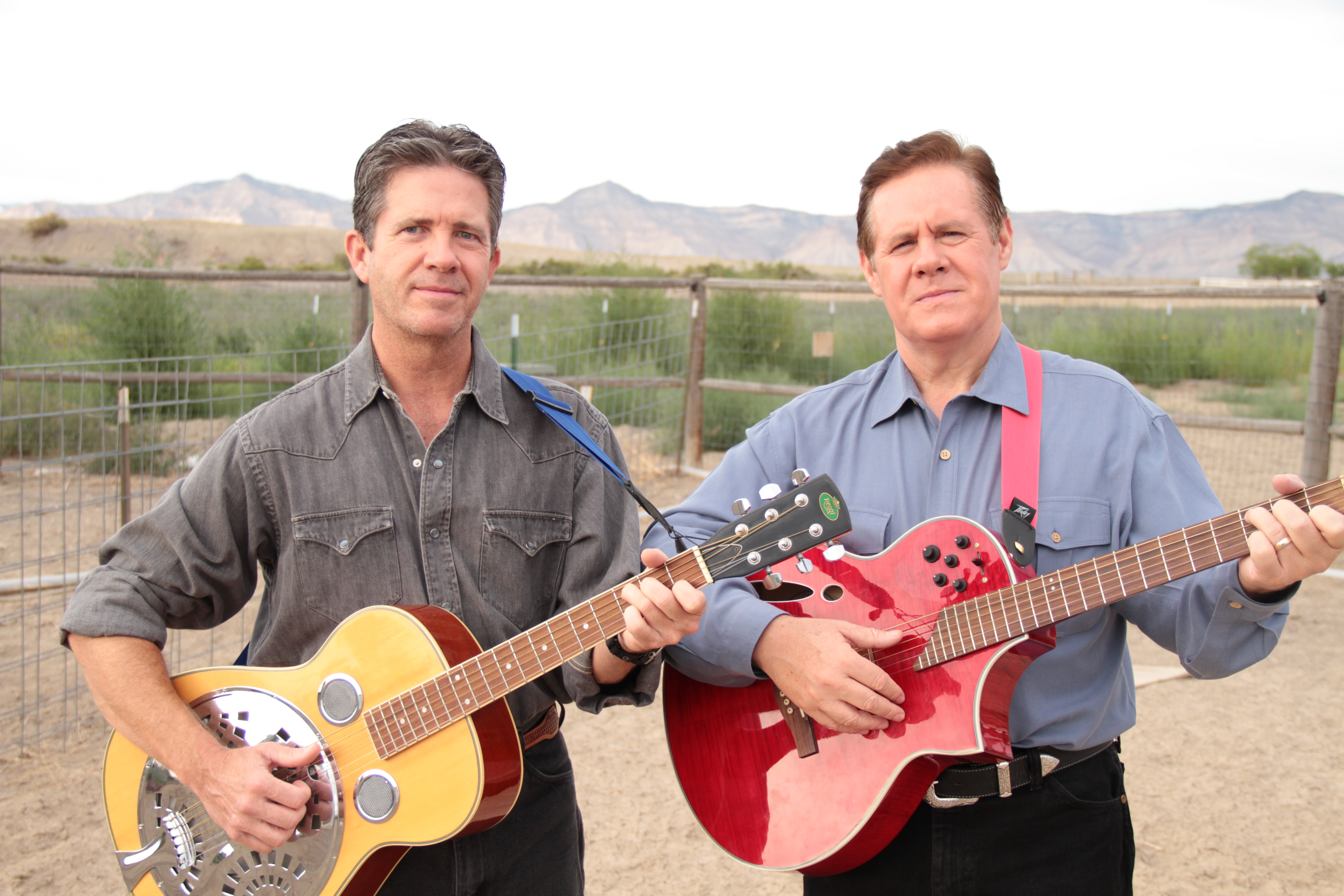 Butch and Ben McCain with their guitars outdoors